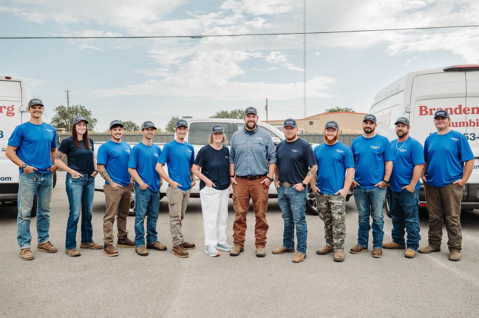 The Brandenburg Plumbing team in front of the company vans