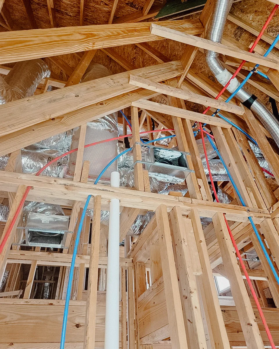 PEX water lines run through new framing on a Brandenburg rough-in