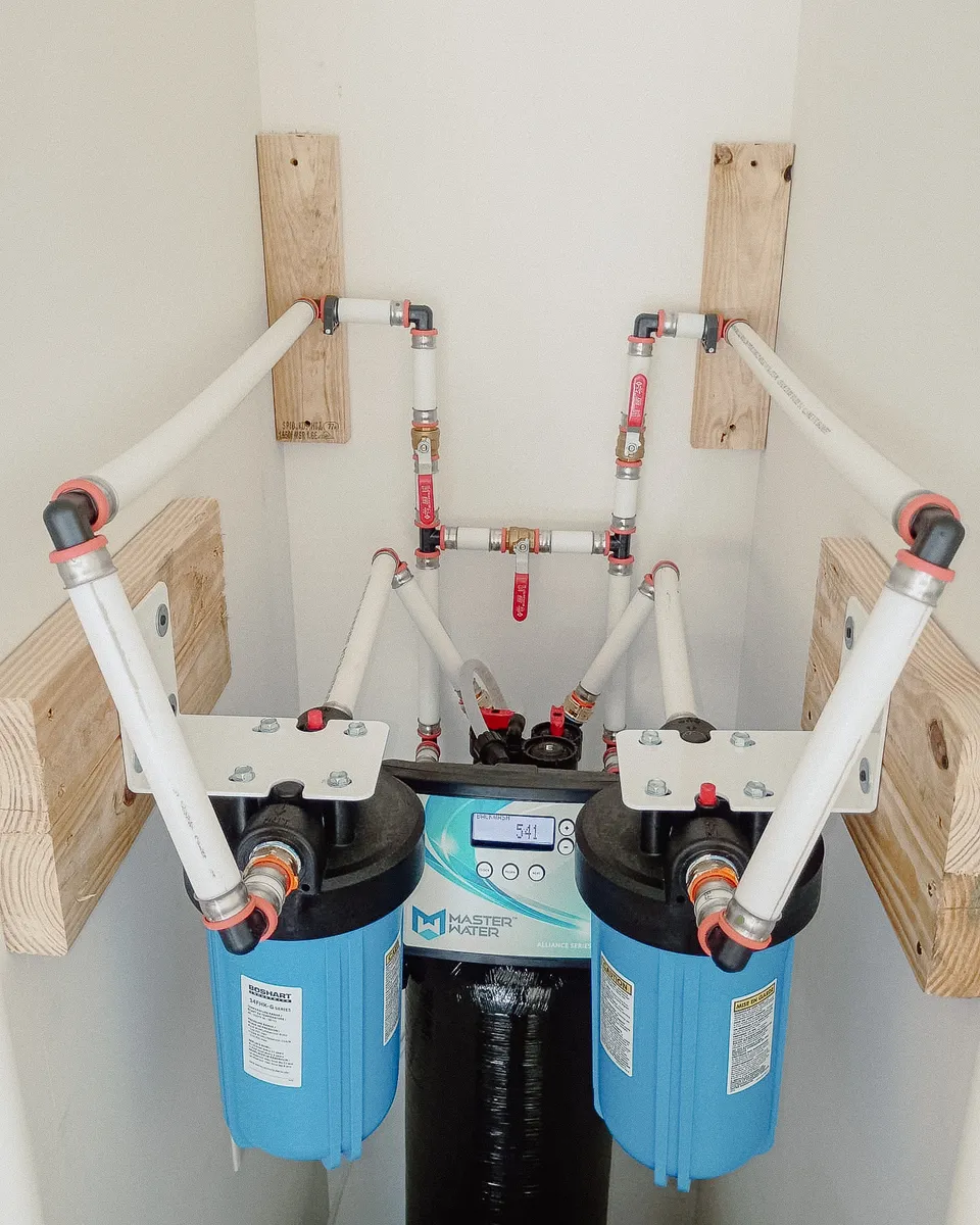 Twin whole-home water filters plumbed on either side of a softener